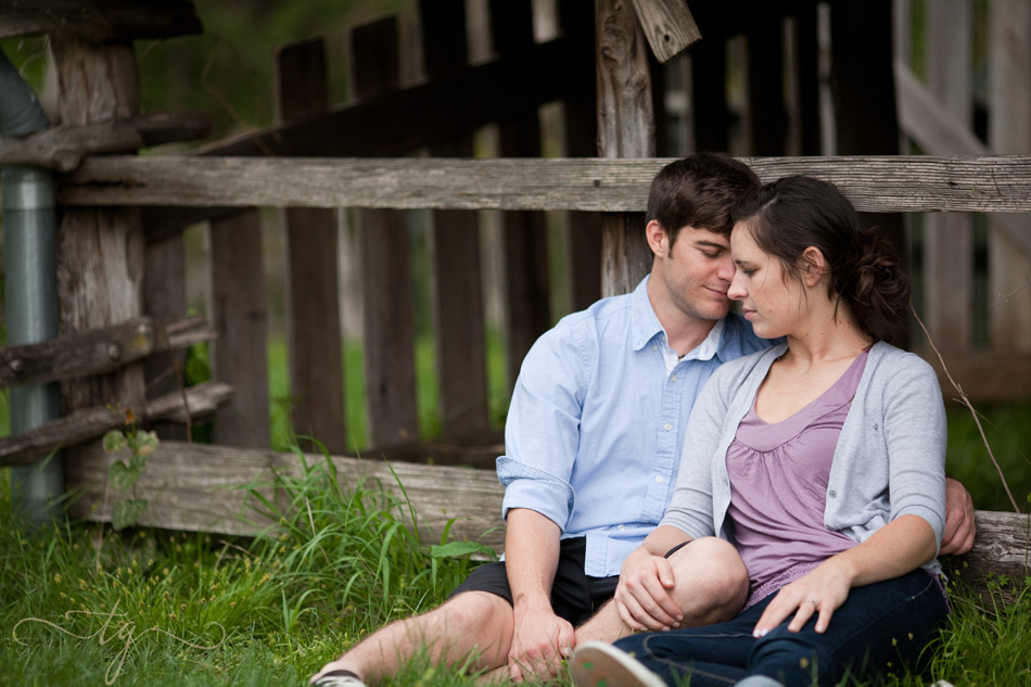 couple sitting at weathered barn